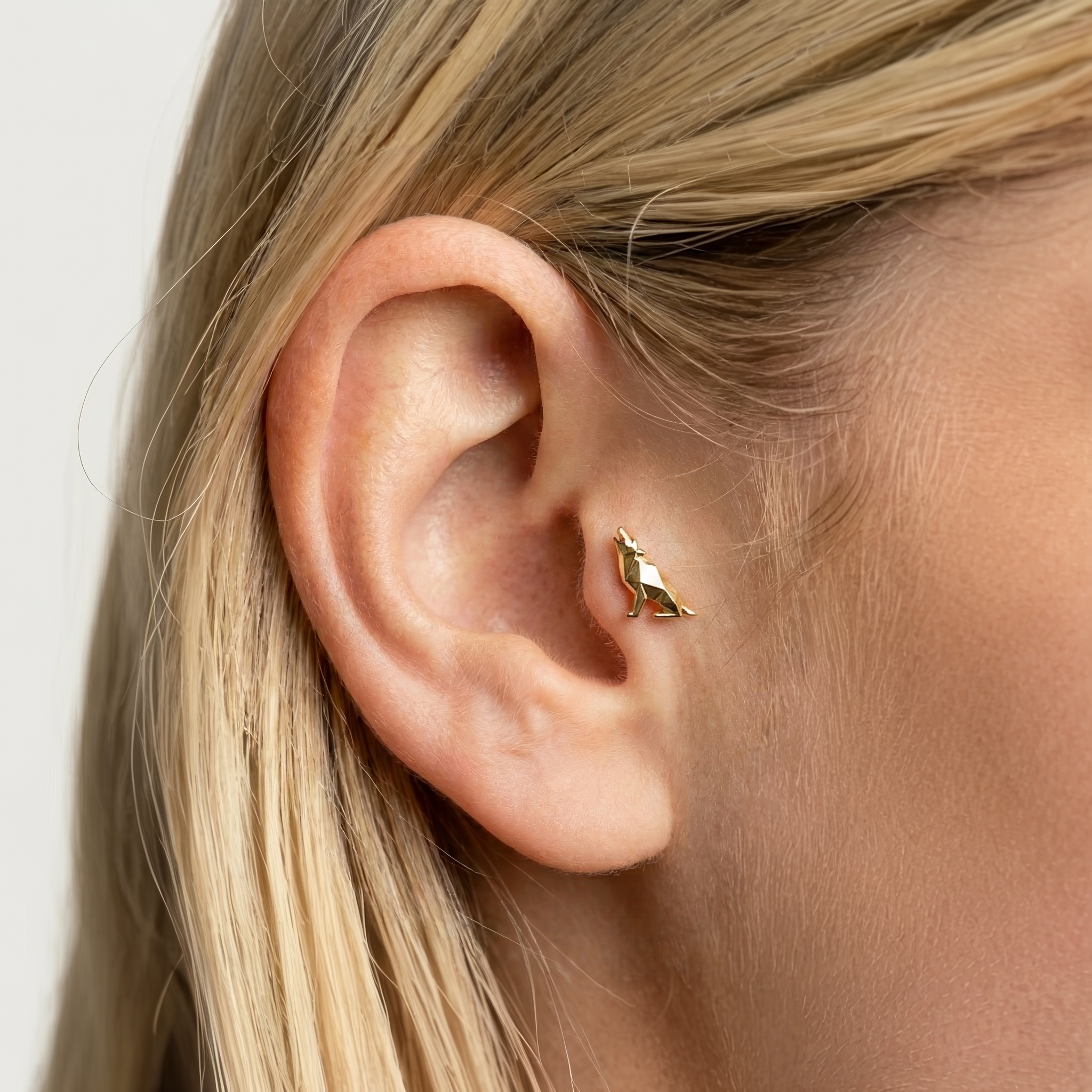 Geometric Howling Wolf Flatback Ear Piercing in 14K gold or silver. A bold, hand crafted wolf piercing with modern lines and lasting comfort.
