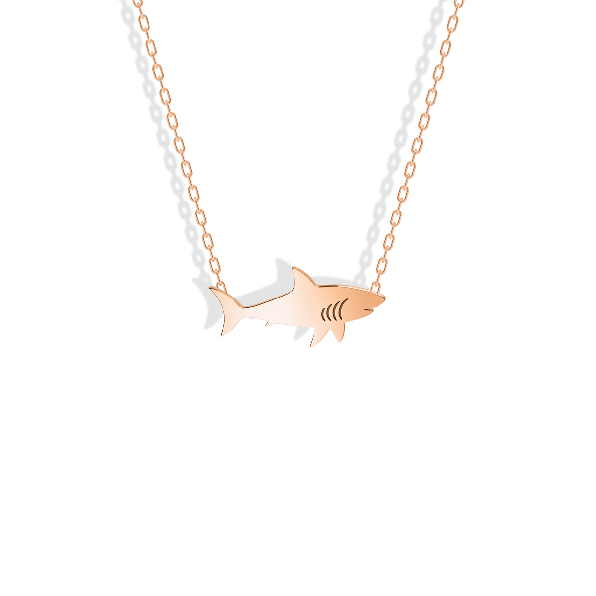 Rose gold shark with a warm reflective line along its back and tail