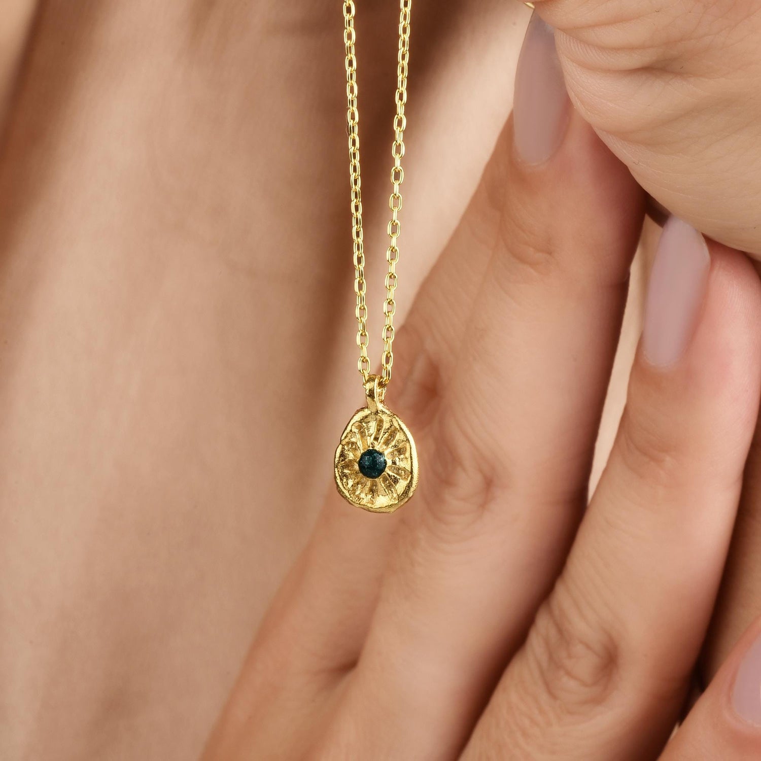 Model wearing the Sun Green Stone necklace, highlighting its golden glow and vivid centerpiece.