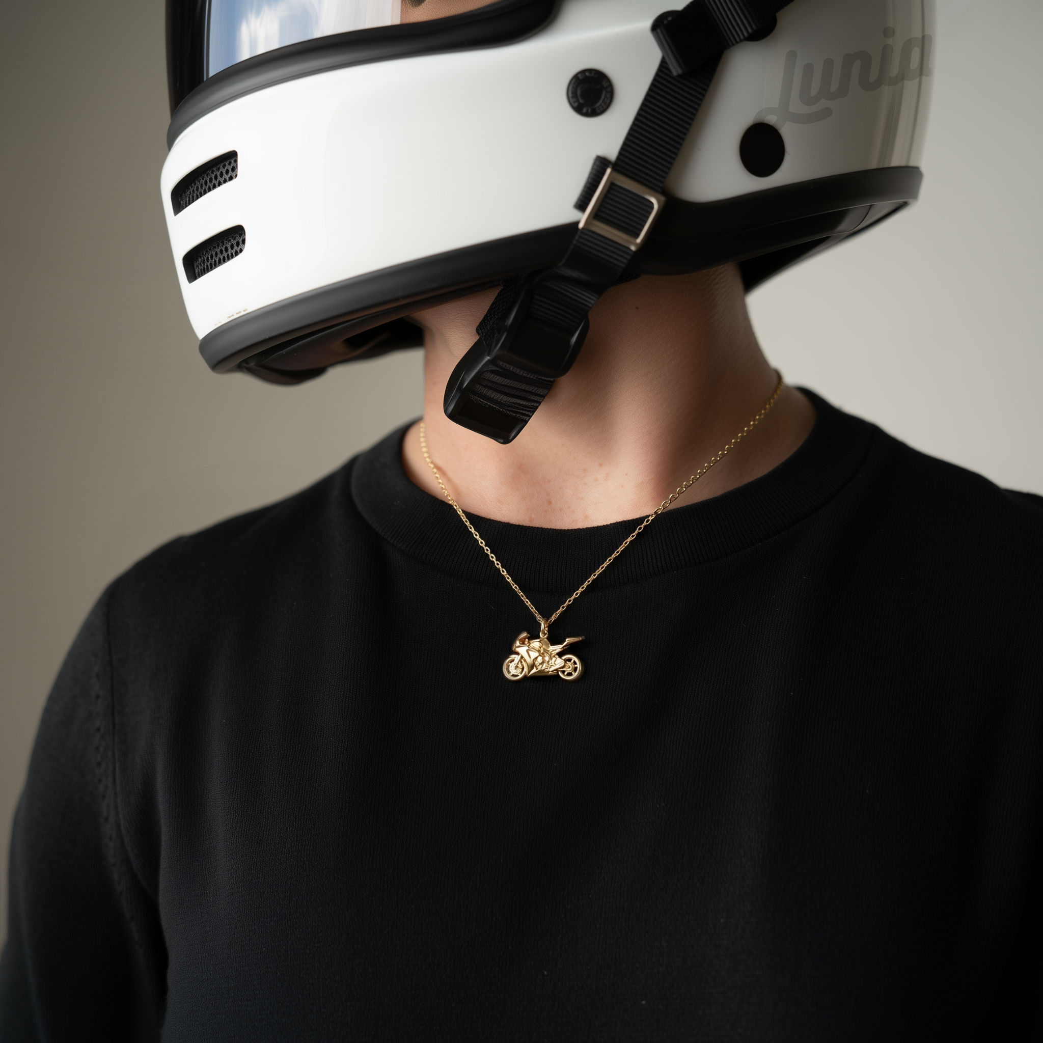 Hand Made biker necklace motorcycle pendant in 14K gold and silver on display