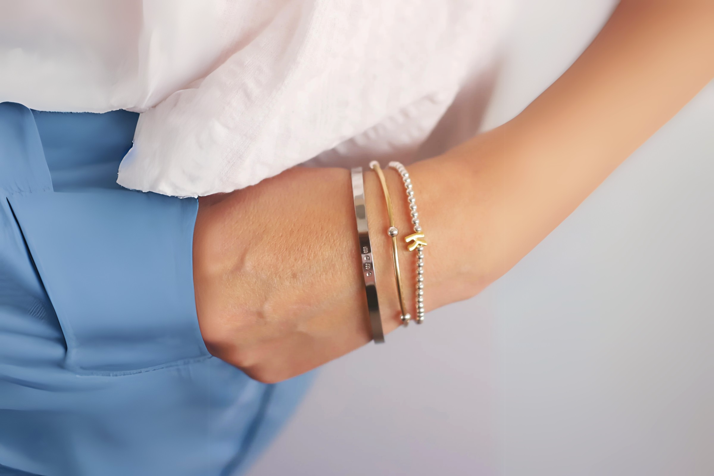 Side-by-side gold and silver jewelry pieces displayed on warm and cool-toned skin, showing how different metals complement undertones.