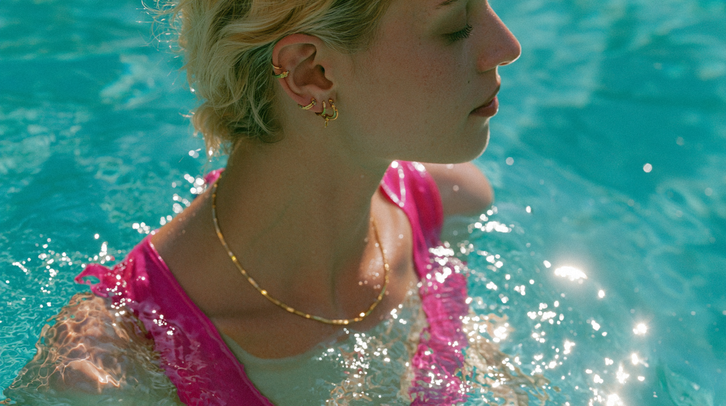14K gold jewelry beside a swimming pool and seawater