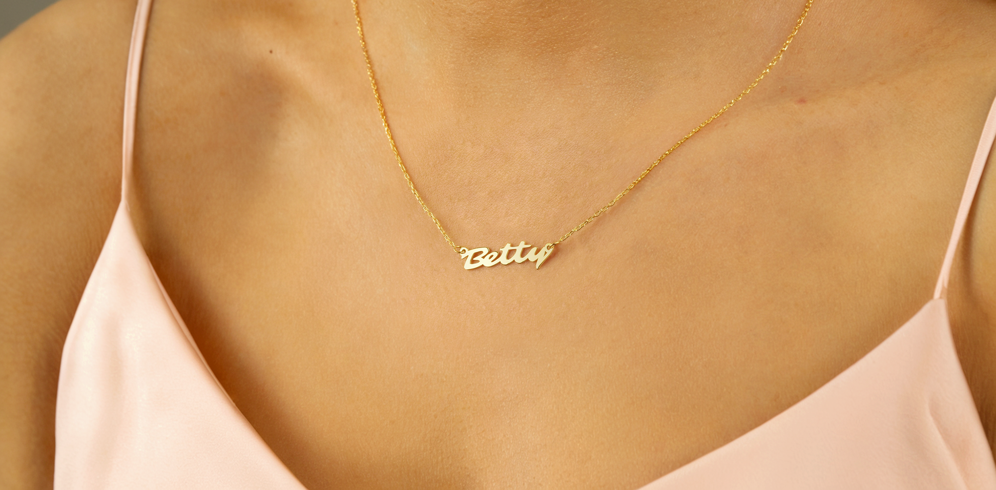 Customizable 14K gold necklaces with delicate nameplates, letter charms, and personalized engraving