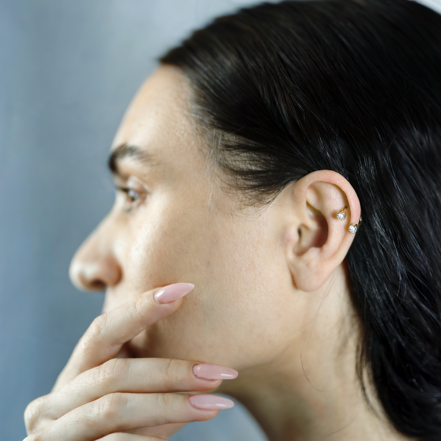 Helix piercing: a sleek, modern ear adornment with intricate design details and urban style