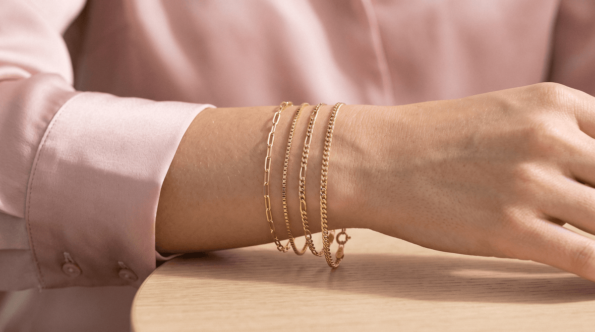 Thin and minimalist 14K solid gold chain bracelets in paper clip, Figaro, Cuban, snake, and herringbone styles