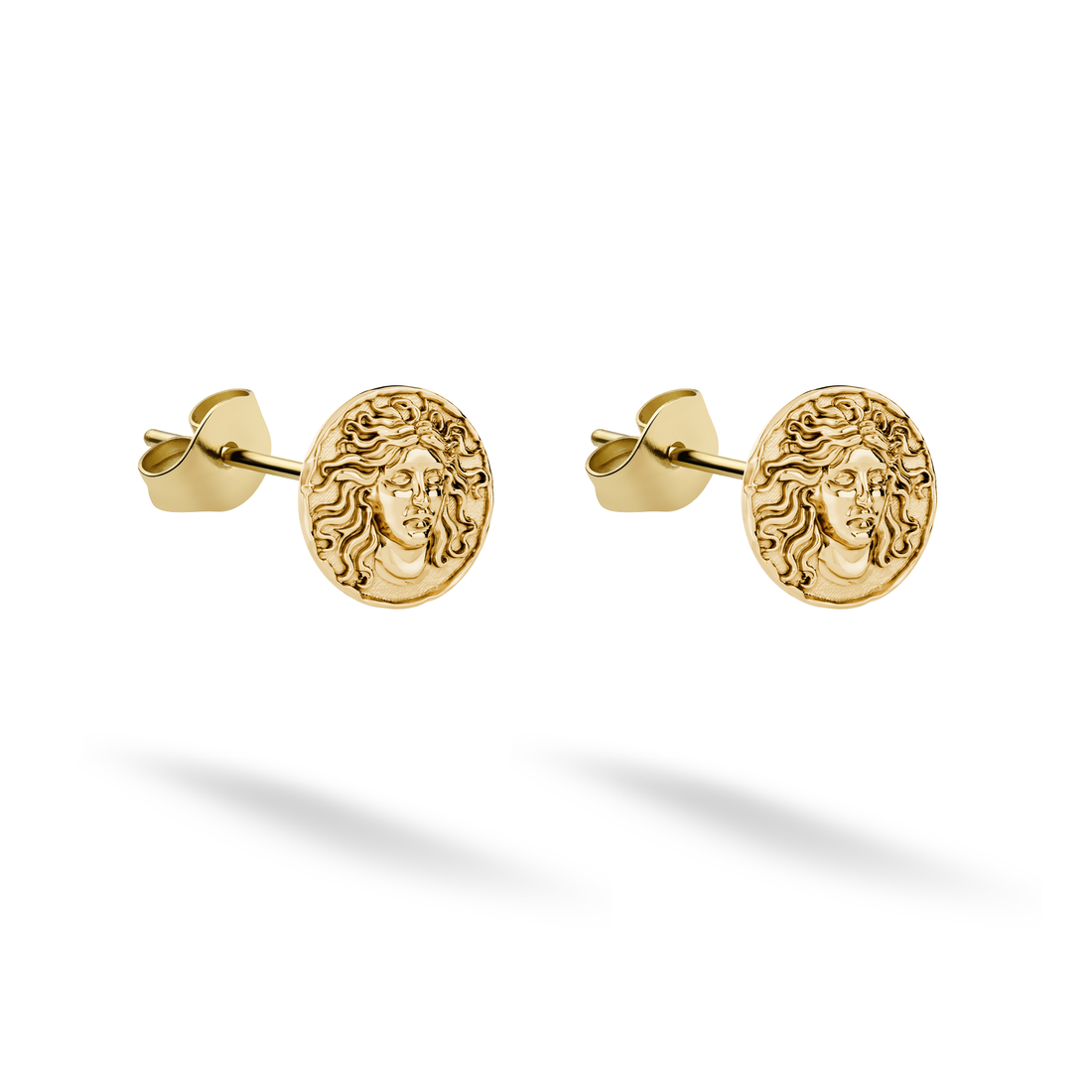 Medusa stud earrings cast in 14K yellow gold display a detailed face framed by curling hair
