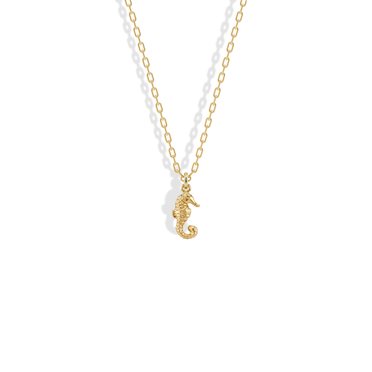 Textured seahorse charm in yellow gold with a curled tail, the Seahorse Pendant Necklace 14K Gold