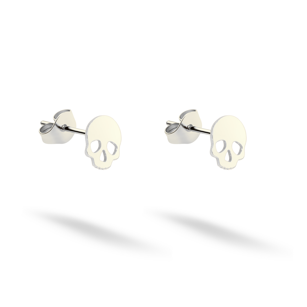 Compact skull studs shown in clean 14K white gold with matching backs