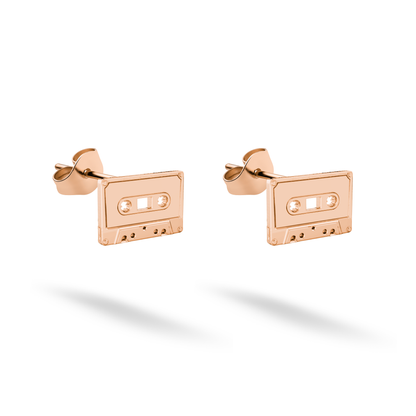 Rose gold cassette studs display their reel openings in a softly glowing blush tone