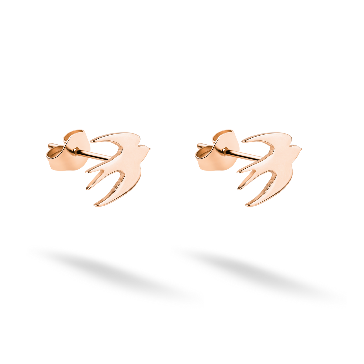 Flying bird studs photographed as a coordinated pair in warm 14K rose gold