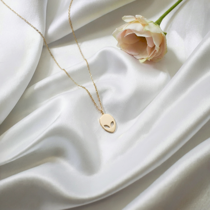 Close up of Alien Face Pendant Necklace 14K Gold Silver nickel free mens necklace with cosmic style