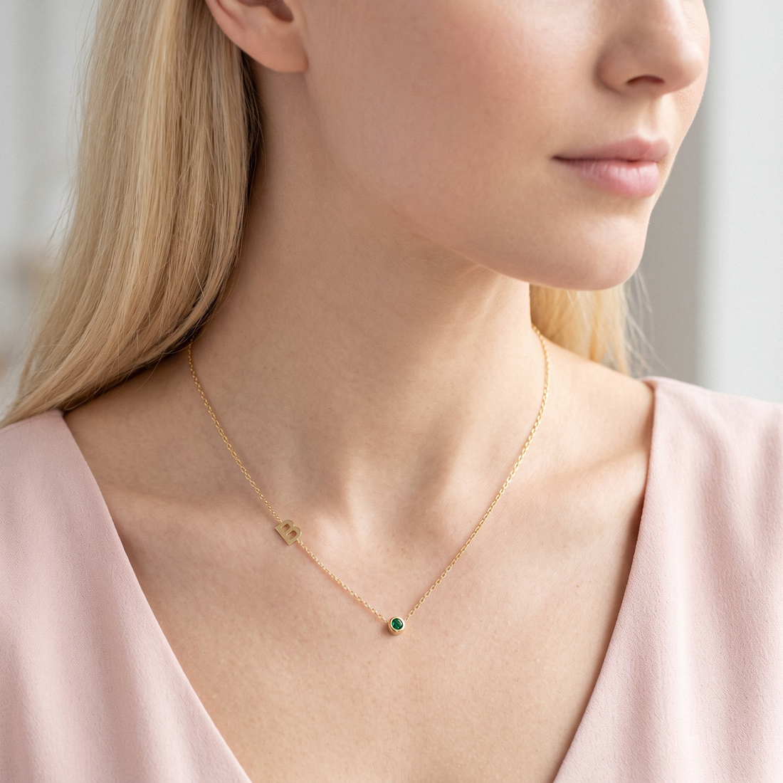 Personalized 14K gold necklace featuring an initial and birthstone charm — a meaningful, elegant piece perfect for gifting or everyday wear.