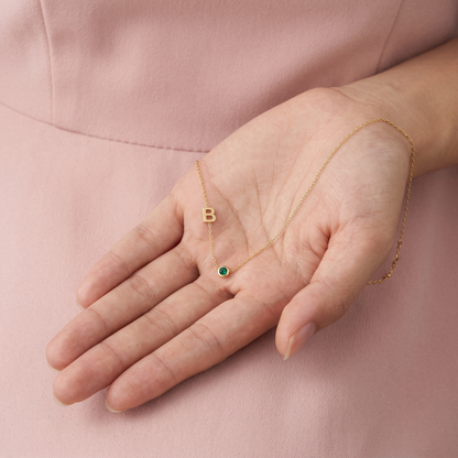 Personalized 14K gold necklace featuring an initial and birthstone charm — a meaningful, elegant piece perfect for gifting or everyday wear.