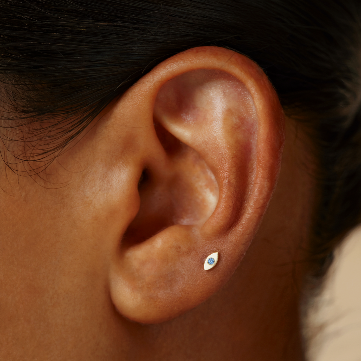 Evil Eye Flatback Ear Piercing brings a touch of charm and protection to your style