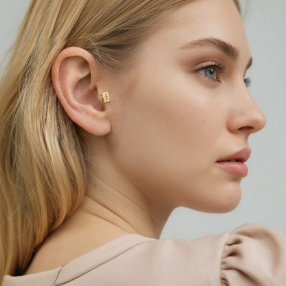 Model wears the miniature cassette flatback in a playful stack inspired by vintage music culture.