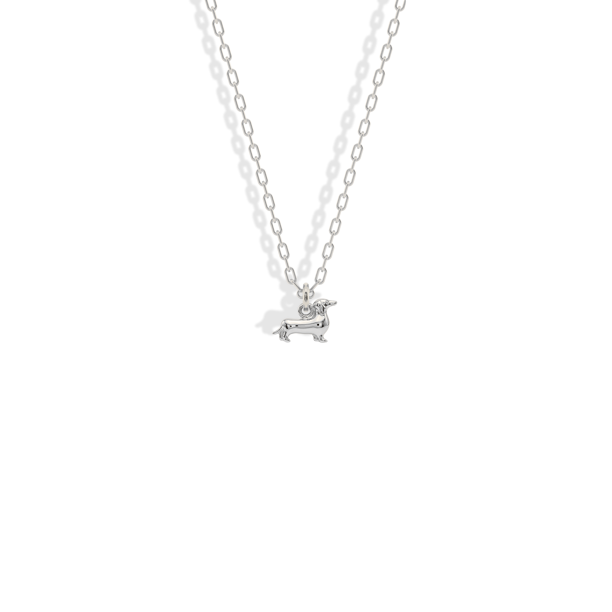 White gold sausage dog charm with a clean silvery finish for cooler jewelry mixes