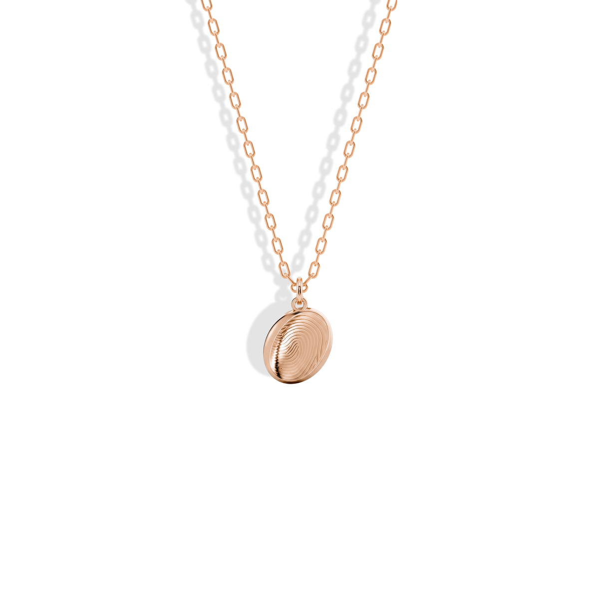 Fingerprint engraving on a 14K rose gold oval, the ridges deepened by the warm tone