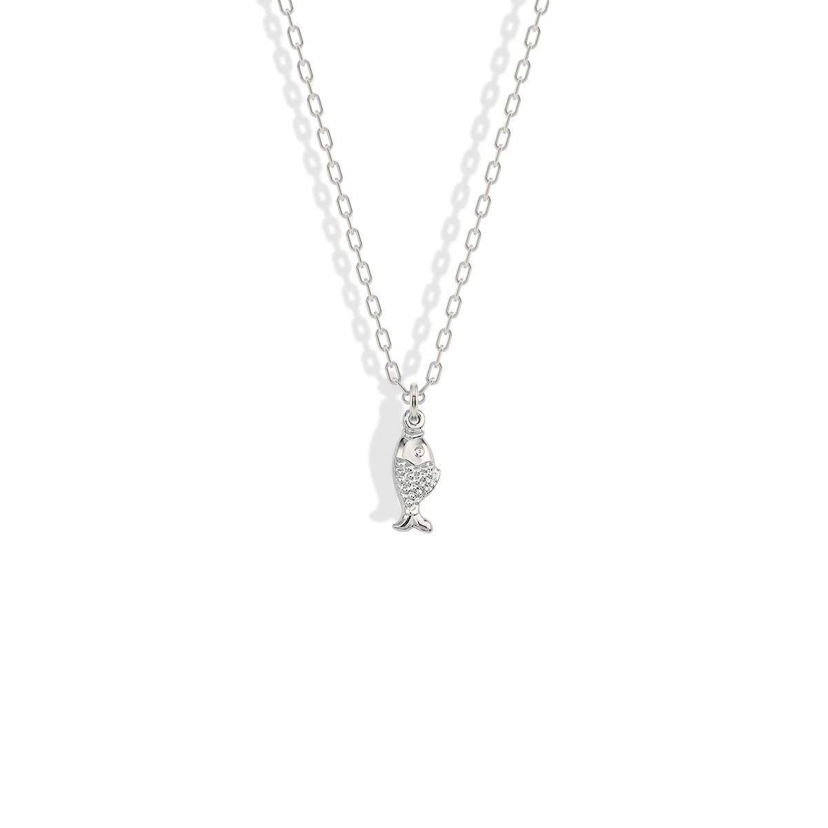 White gold fish pendant, crisp and cool against silver-toned jewelry