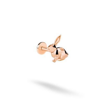 Rose gold adds a gentle copper-pink glow to the angular rabbit motif and its upright ears.