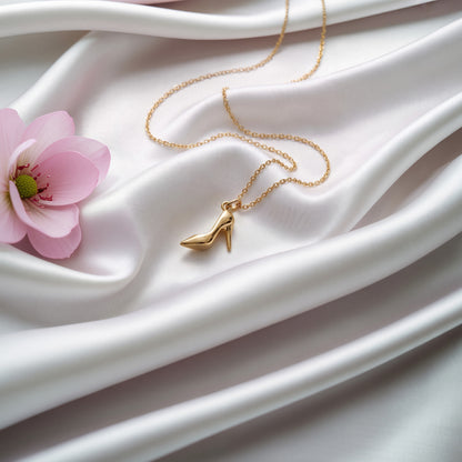 High heel pendant on ivory silk with a pink magnolia bloom beside it