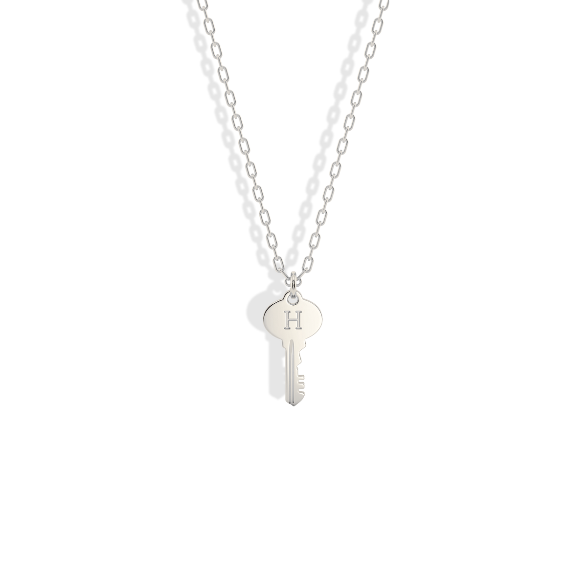 Bright, cool 14K white gold version of the key initial necklace, close in look to polished silver