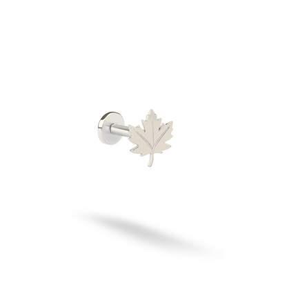 Silvery 14K white gold emphasizes the fine vein lines and serrated outline of the maple leaf piercing.