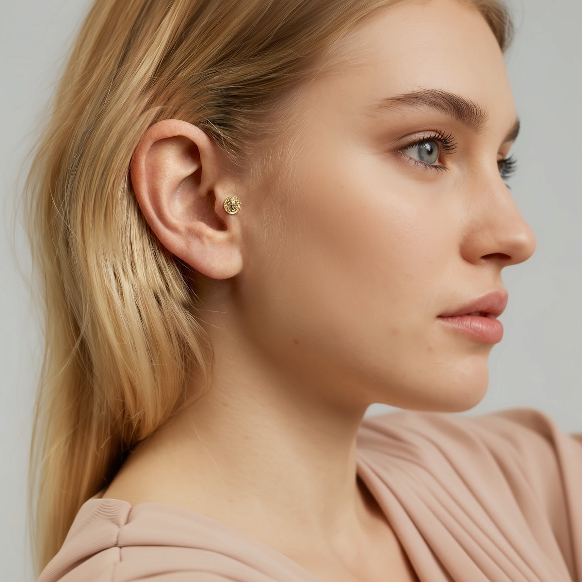 Model wearing the Medusa flatback piercing as a bold miniature accent with an understated everyday look.