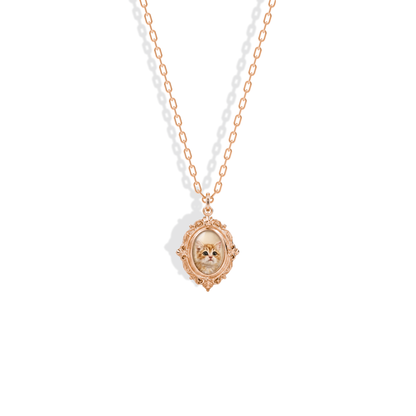 Ornate photo locket in 14K rose gold, a warm border around the enamelled portrait