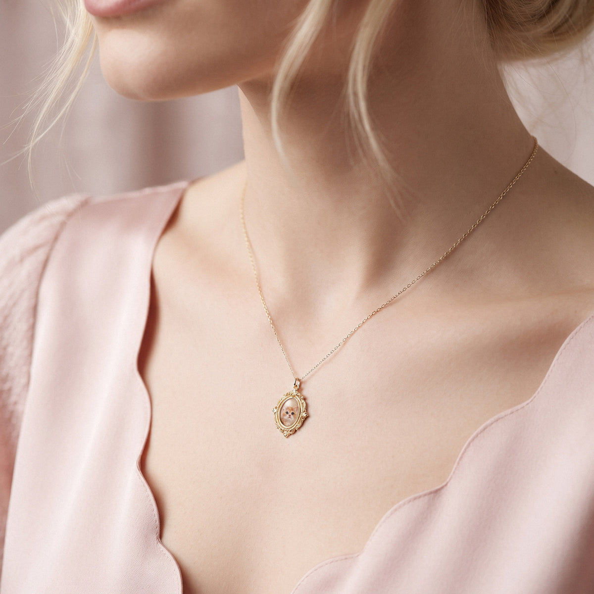 Scalloped pink neckline and an ornate photo locket resting against the collarbone