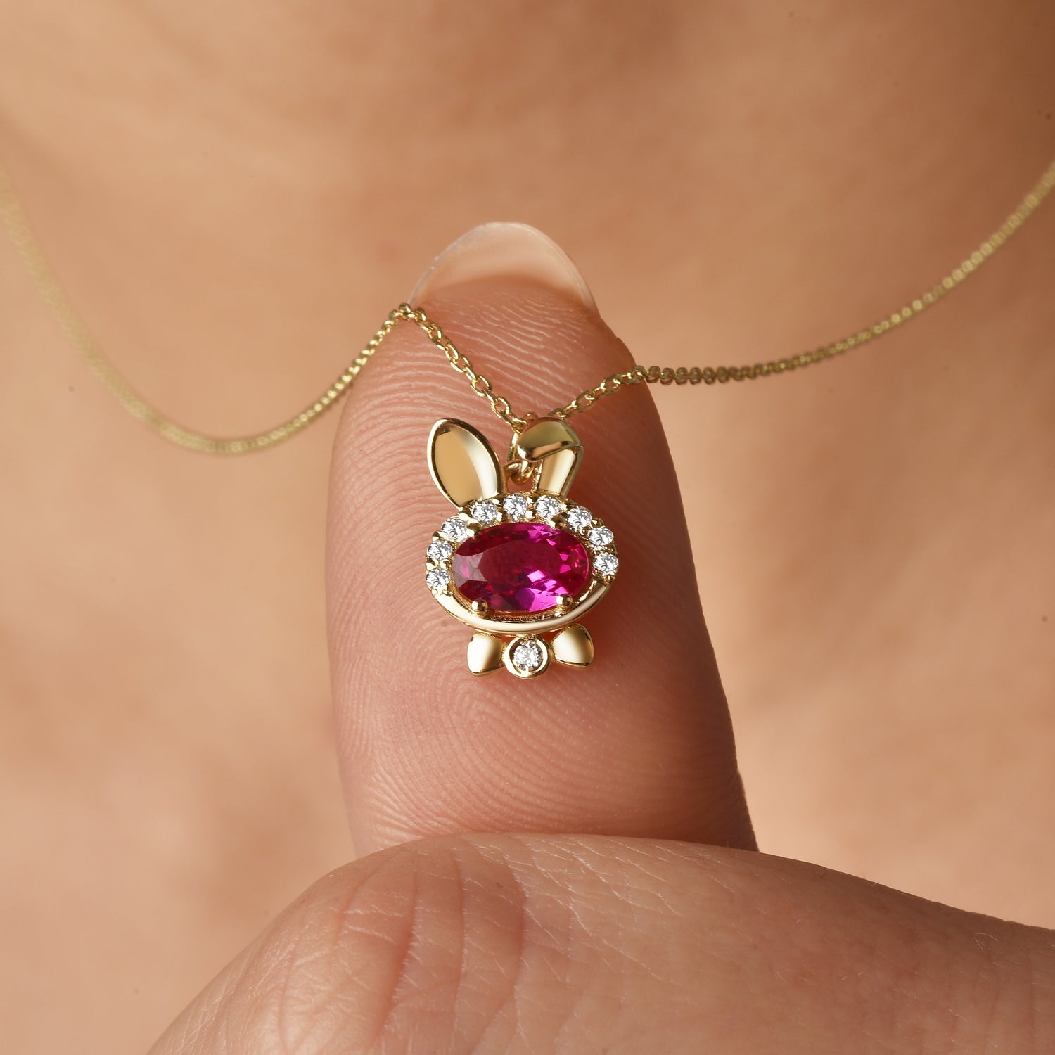 Close-up of Rubby Jewelry bunny necklace featuring bow tie rabbit design and Rubby minimalist style