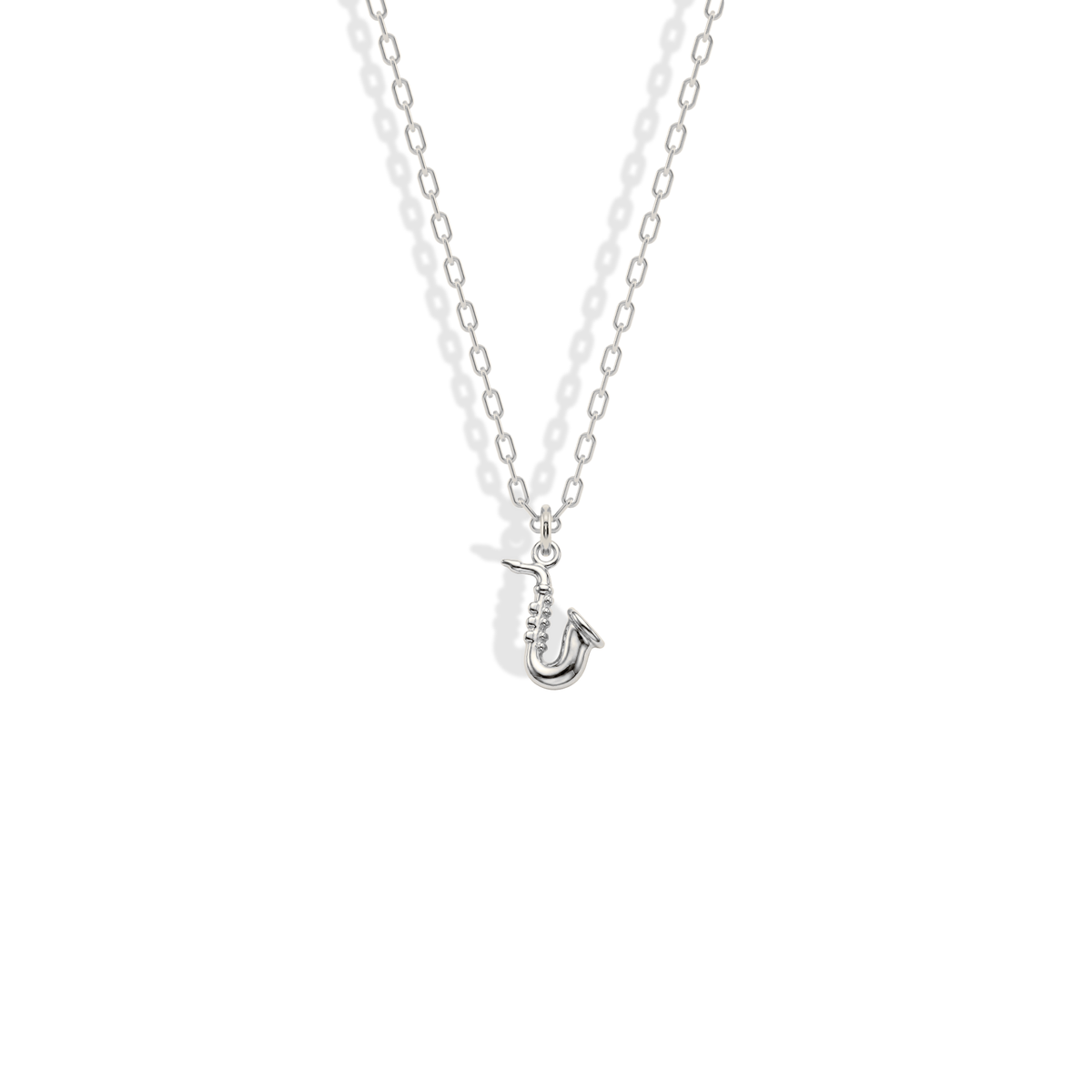 White gold instrument pendant, its cool shine sharpening the compact curved outline