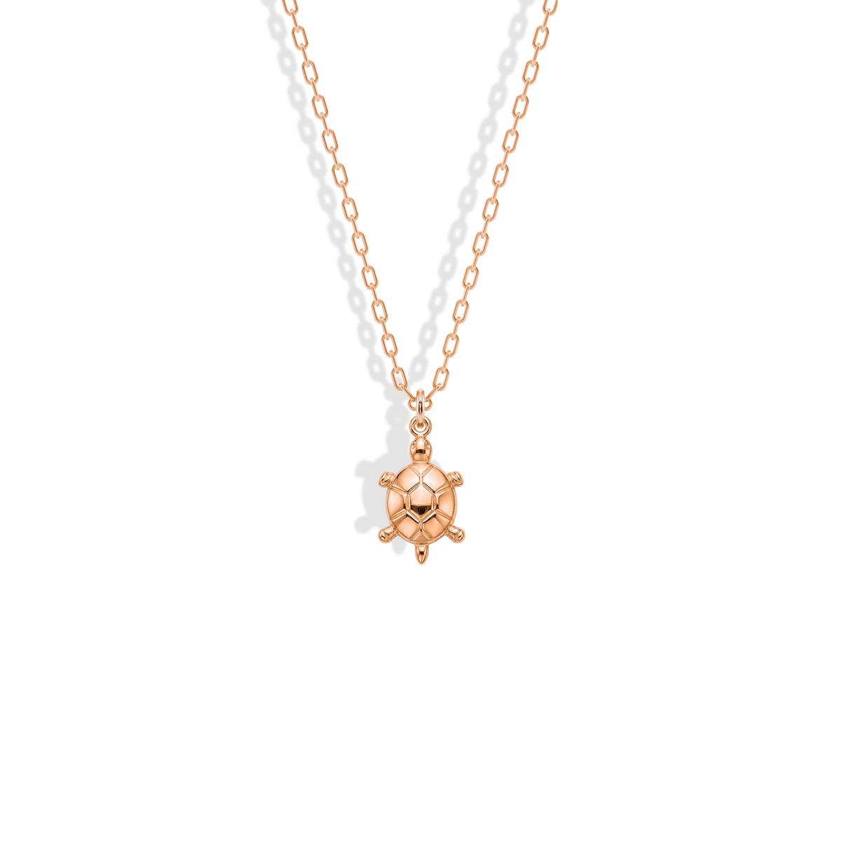 Rose gold sea turtle, its shell plates deepened by the blush metal