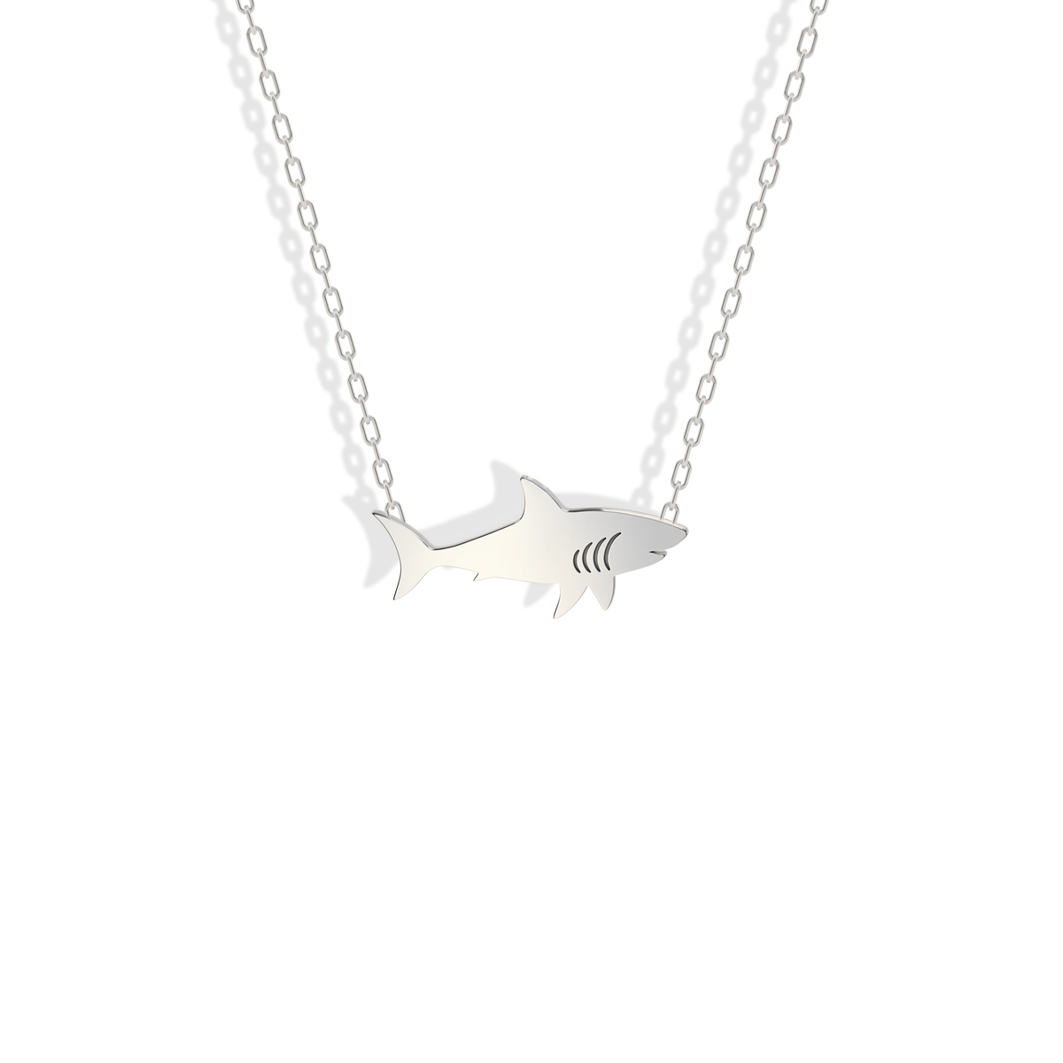 A crisp silvery finish runs from pointed nose to tail on the white gold shark charm