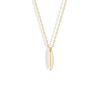 Studio shot of the Surfboard Pendant Necklace 14K Gold / Silver, a narrow yellow gold board hanging point down