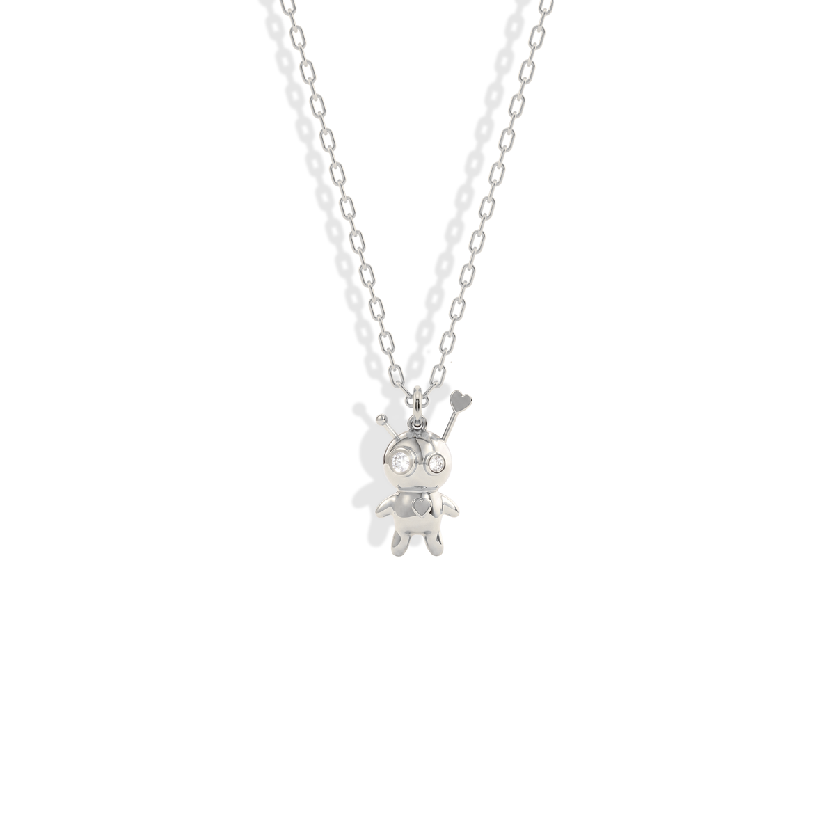 Sharp stitched outline of the doll pendant picked out in cool 14K white gold